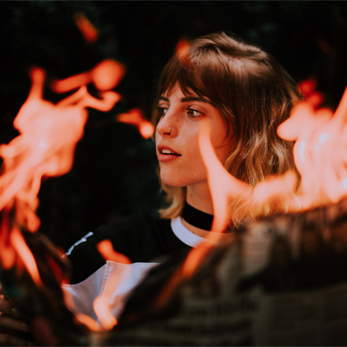 Burning world news. Photo by Matheus Bertellinewspaper-burning-in-hands-of-young-woman-13871563